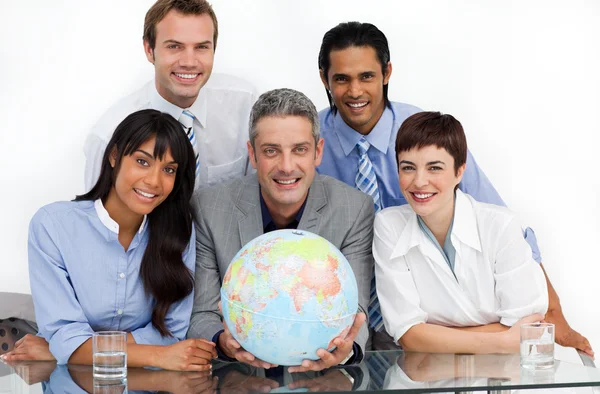 Confident business partners holding a globe