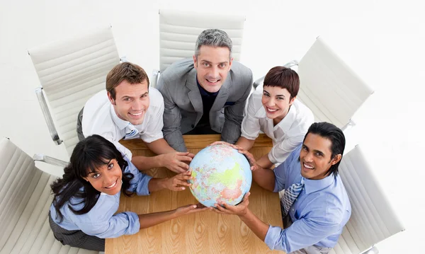 Smiling business holding a globe