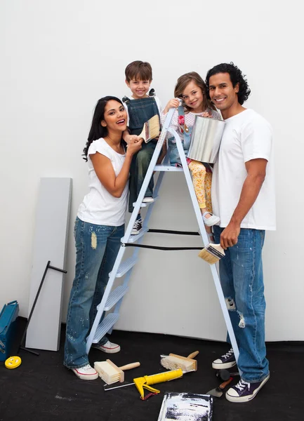 Happy young family renovating a room