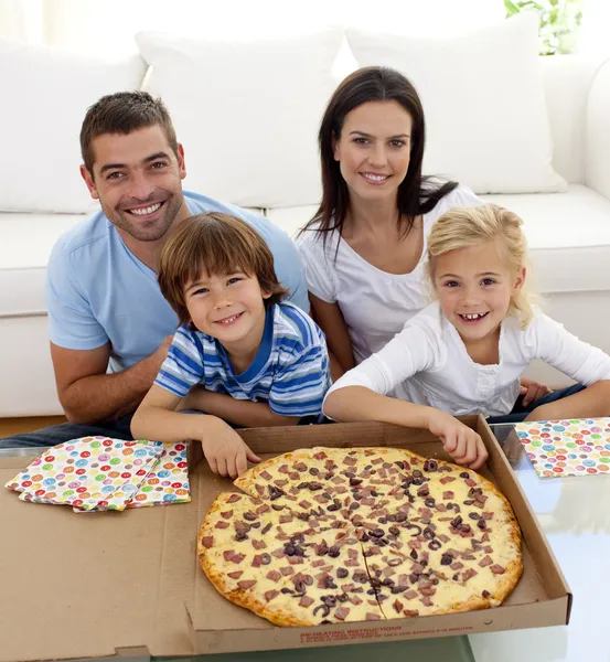 Family eating pizza on sofa — Stock Photo #10299699