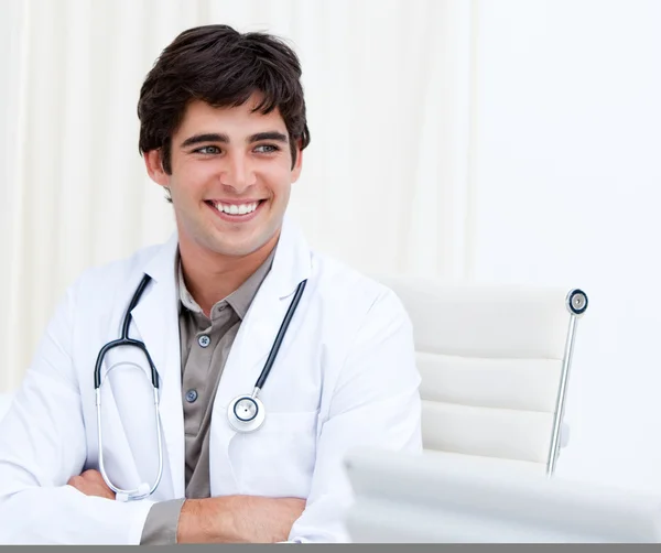 Self-assured male doctor smiling in his office