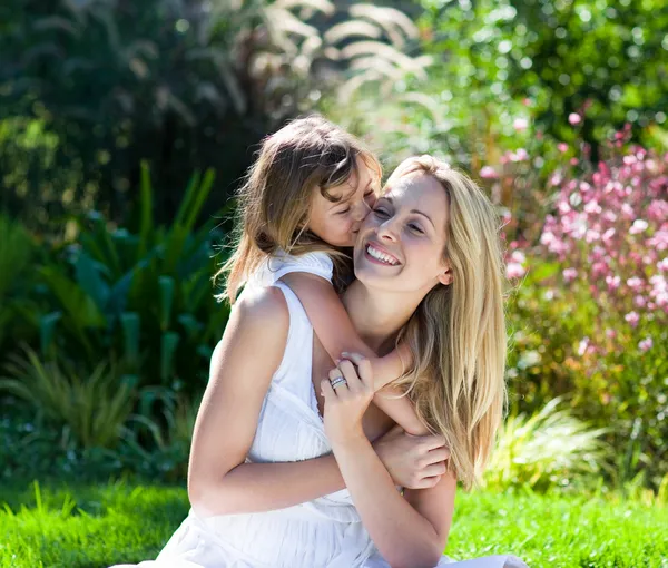 Little girl kissing her mother