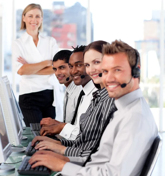 Business team in a call center with a bright female leader