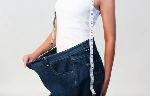 Close-up of woman wearing big jeans focus on woman
