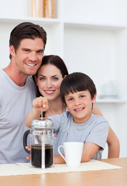 Portrait of parents and their son preparing coffee