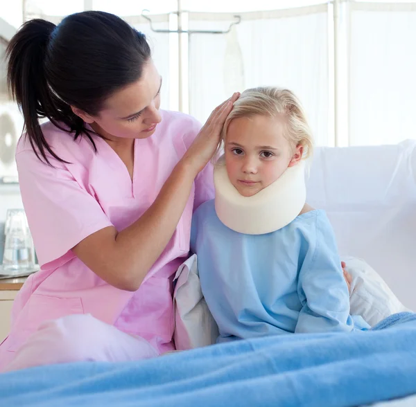 A nurse looking after an upset girl with a neck brace