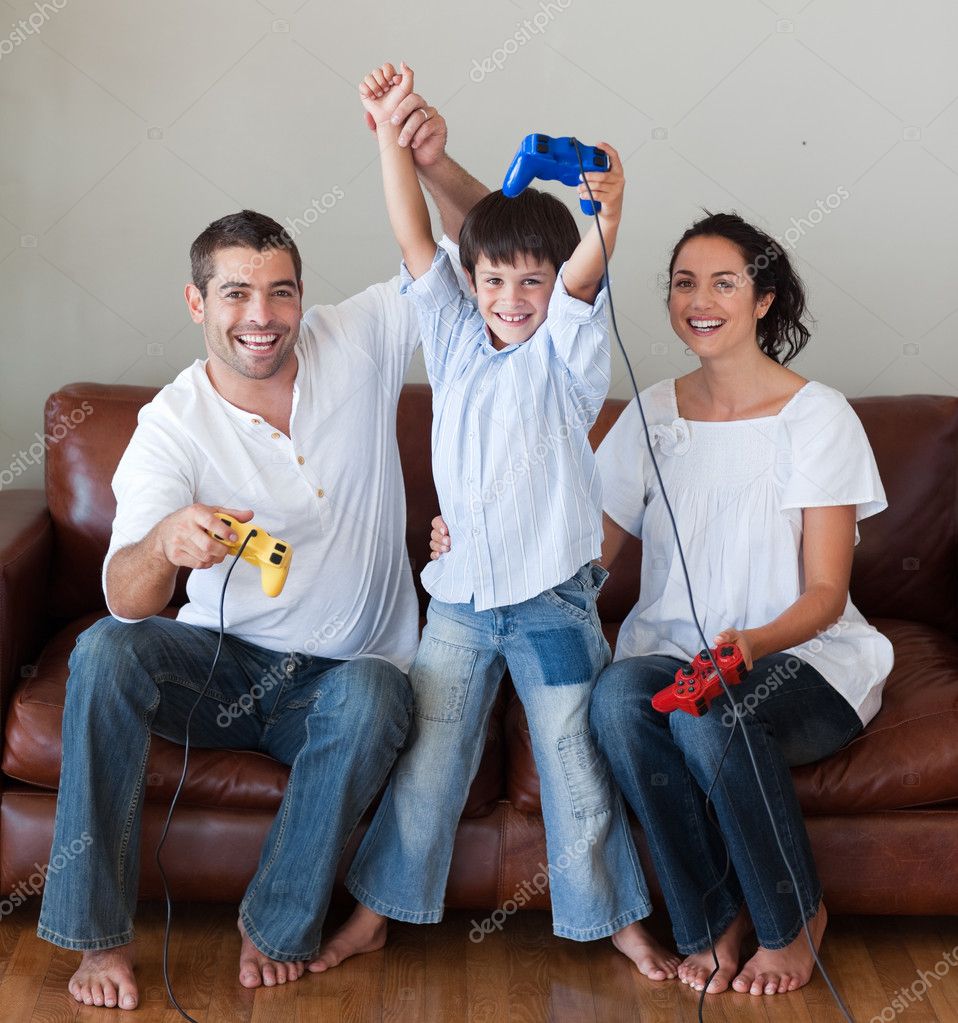 Happy family playing video games in the living-room | Stock Photo ...