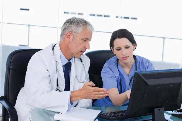 Professional medical team working with a computer