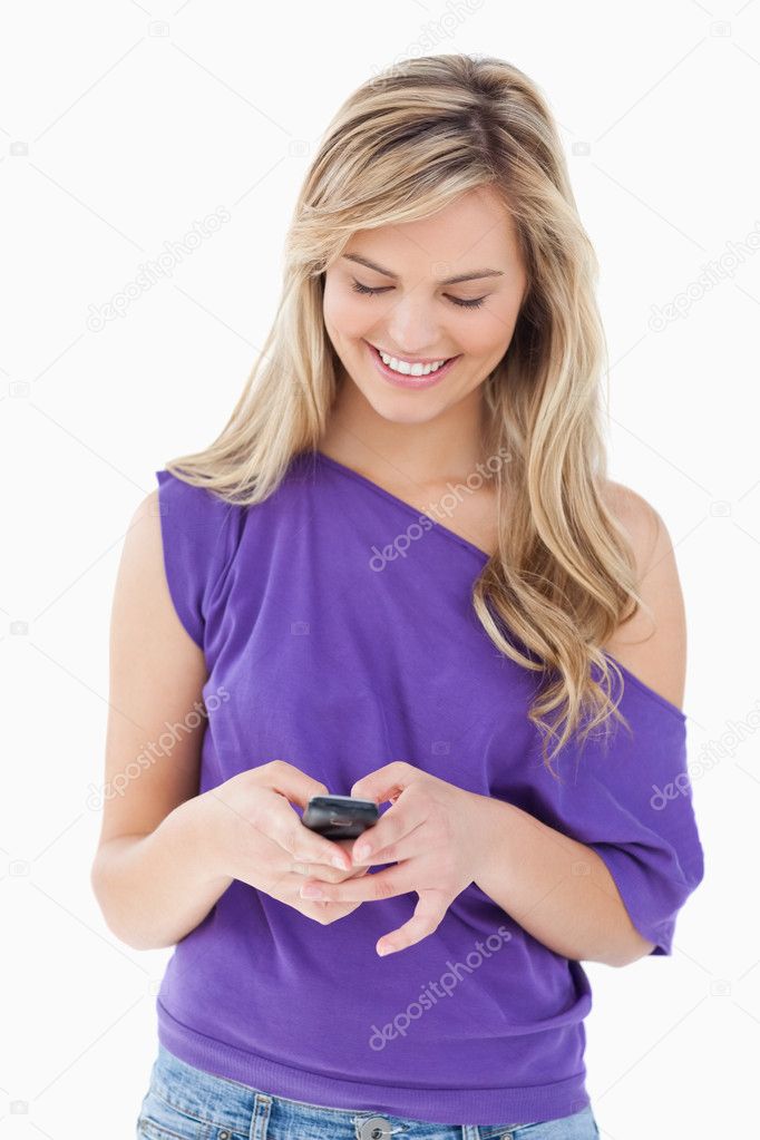 Smiling Blonde Woman Holding Her Cellphone Stock Photo