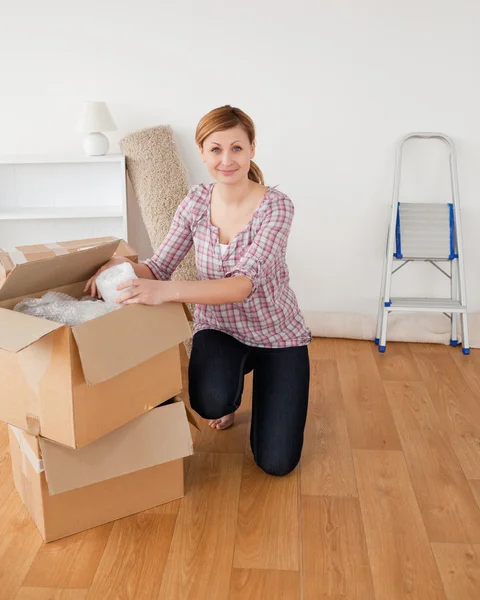 Cute blond-haired woman preparing to move house