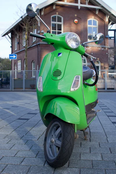 Motor scooter on background of old dutch building