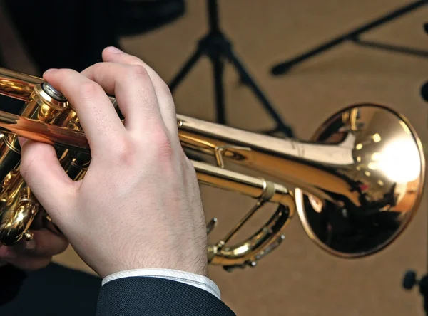 The jazz musician plays music on a trumpet
