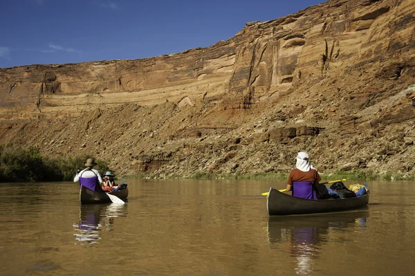 Family in canoes on desert river