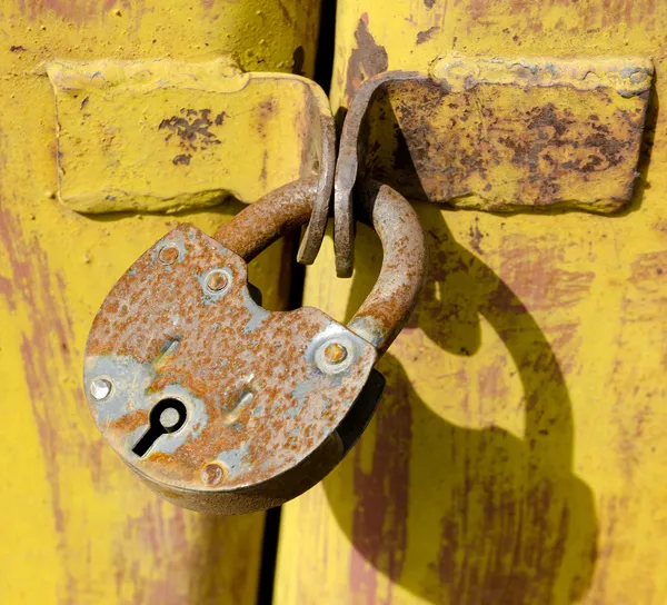 Metal rusty lock closes the door garage
