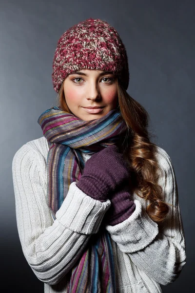 Beautiful girl in winter clothes. Studio shot