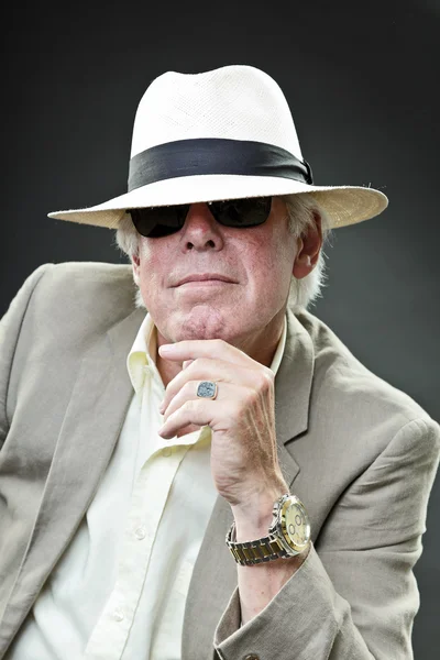 Senior gangster man wearing light suit black sunglasses and hat.