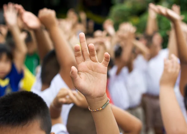 Hand raised in schoolyard