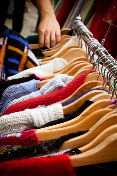 Rack of jumpers at market