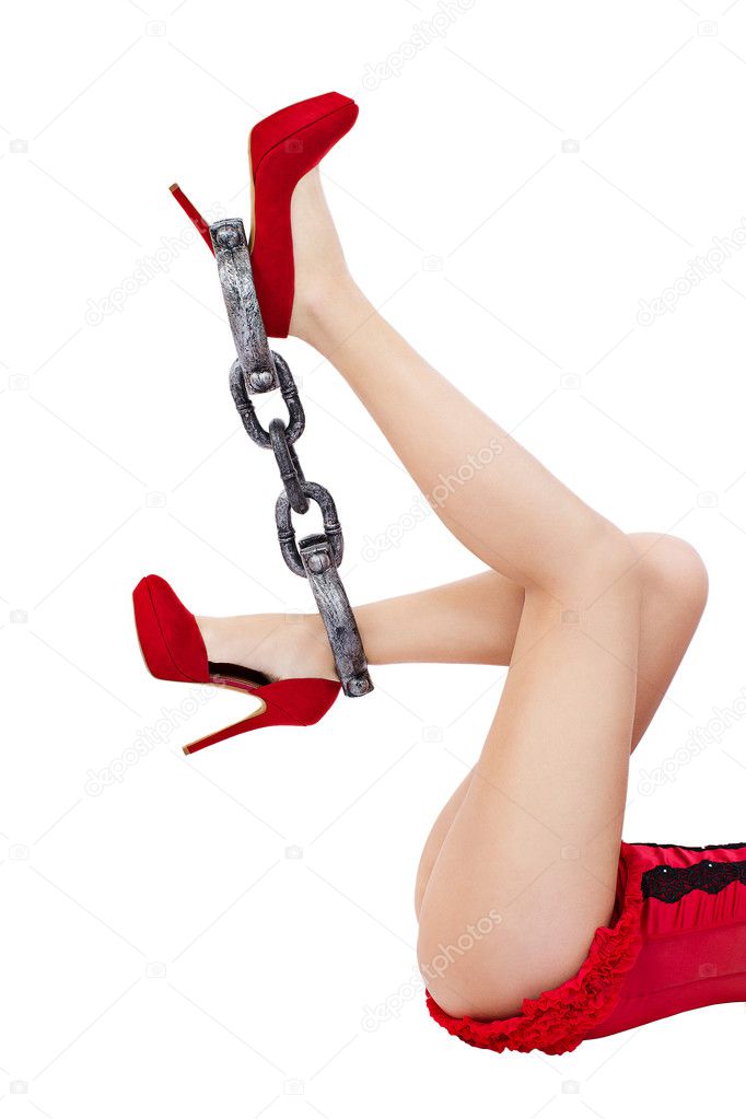 Slim Long Woman Legs In Red High Heels Shoes In Shackles Stock Photo