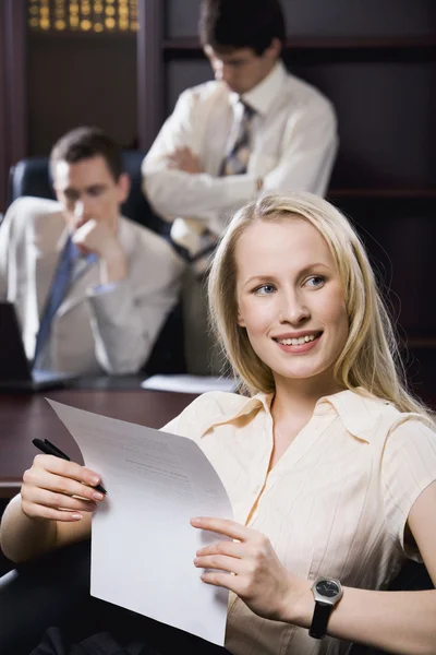 Photo of attractive secretary holding paper during business conversation