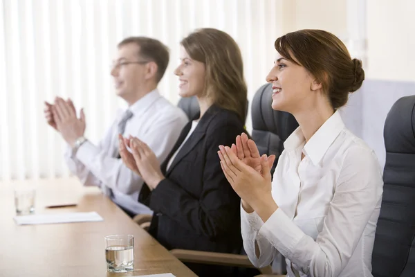 Image of successful business clapping in the office