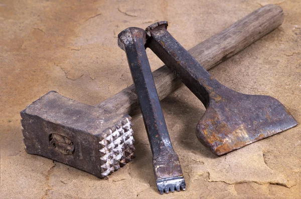 A hammer with two chisels