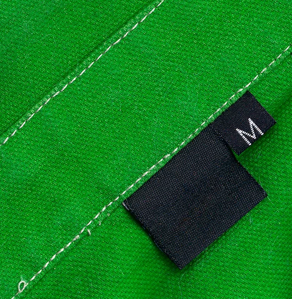 Black tag on a clothes — Stock Photo, Image