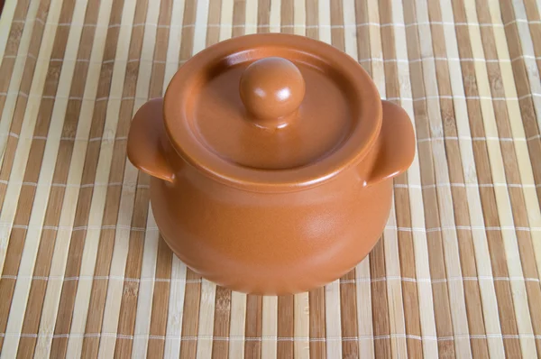 stock image Ceramic pot on the striped mat