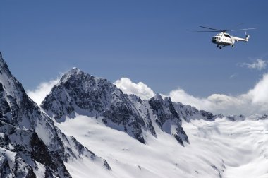 Helicopter in high mountains clipart