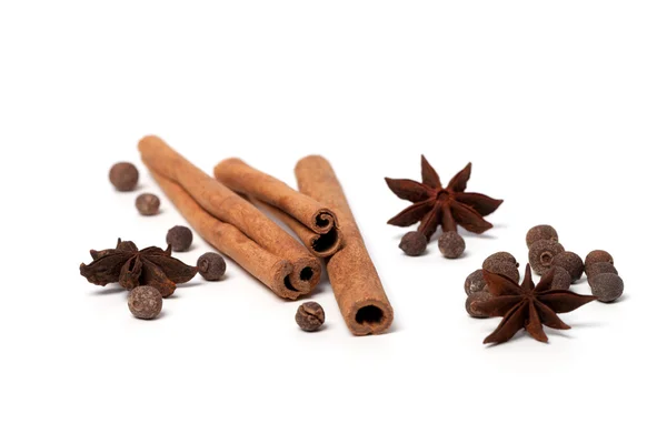 Black peppercorns, anise stars and cinnamon sticks — Stock Photo, Image