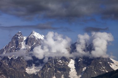 Mt. Ushba in clouds, Caucasus Mountains, Georgia, Svaneti. clipart