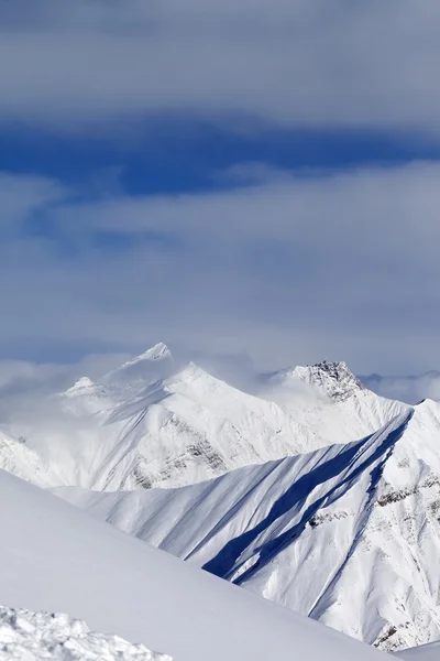 Ski helling en besneeuwde bergen — Stockfoto