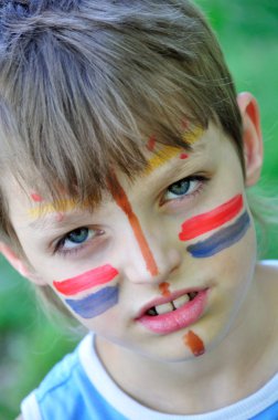 Football fan child with painting on his face clipart