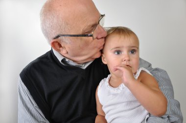 Senior man kissing daughter clipart