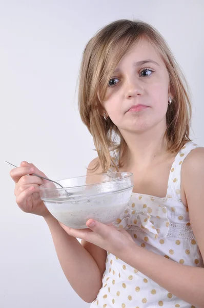 Thoughful child with a bowl of milk porridge — Stock Photo, Image