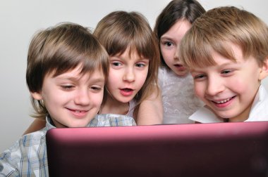 Group of children friends playing computer games clipart