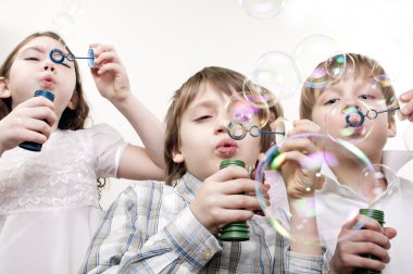 Children blowing bubbles clipart