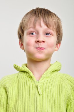 Elementary boy making funny faces clipart