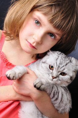 Child with her pet cat clipart