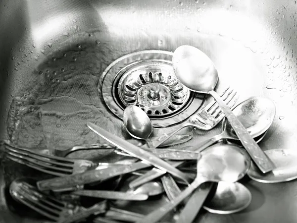 Steel kitchen sink with dirty utensils — Stock Photo, Image