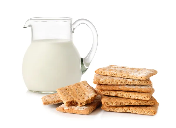 Glass jug with milk and cracker — Stock Photo, Image