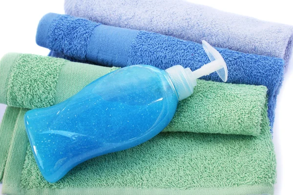 Towels and liquid soap bottle — Stock Photo, Image