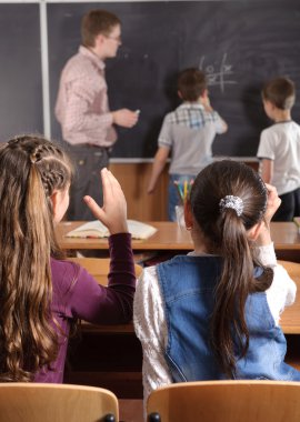 Male teacher in front of elementary age pupils clipart