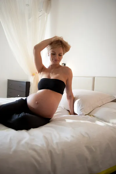 Hamile kadın yatakta. — Stok fotoğraf