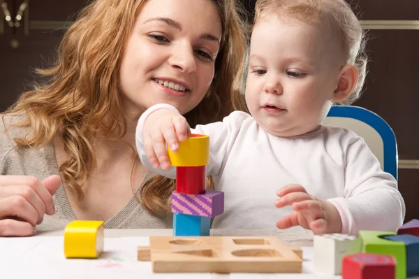 Mother and baby daughter building tower Εικόνα Αρχείου