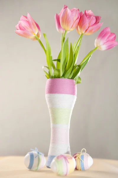 Pink tulips, Easter eggs and yarn wrapped bottle — Stock Photo, Image
