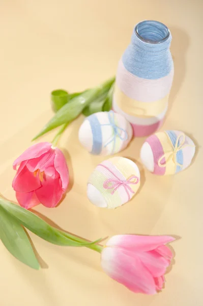 Pink tulips, Easter eggs and yarn wrapped bottle — Stock Photo, Image