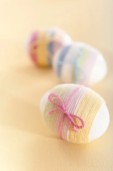 stock image Striped yarn wrapped Easter eggs