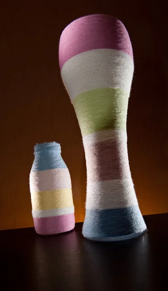 Yarn wrapped glass bottles — Stock Photo, Image