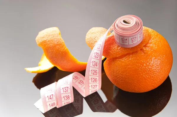 stock image Orange peel and measuring tape